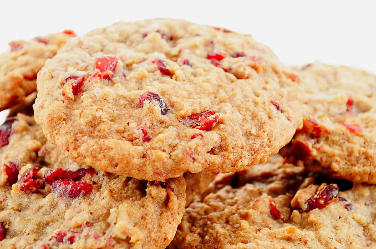 Close up of a pile of cranberry and hazelnut chip cookies.