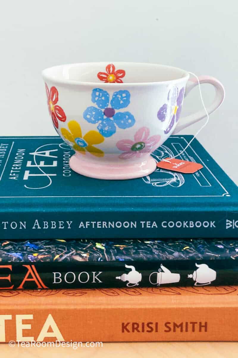 Cup of tea placed on three books about tea
