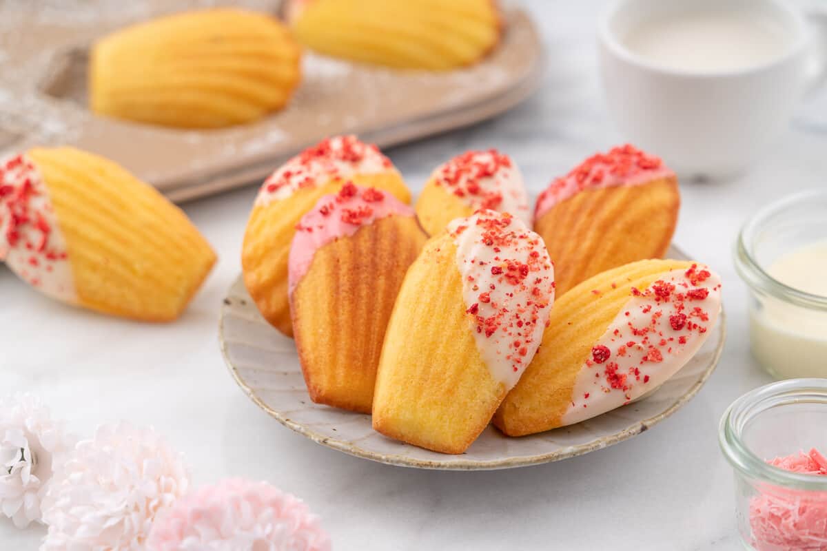 Bowl of Madeleines dipped in White Chocolate with red sprinkles