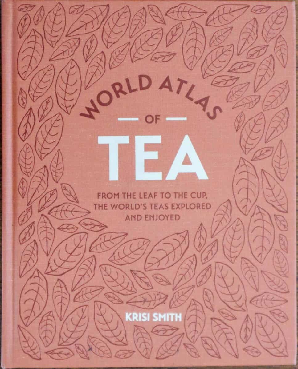 Book cover for "the world atlas of tea" by Krisi Smith with light broan background and line drawn tea leaves.