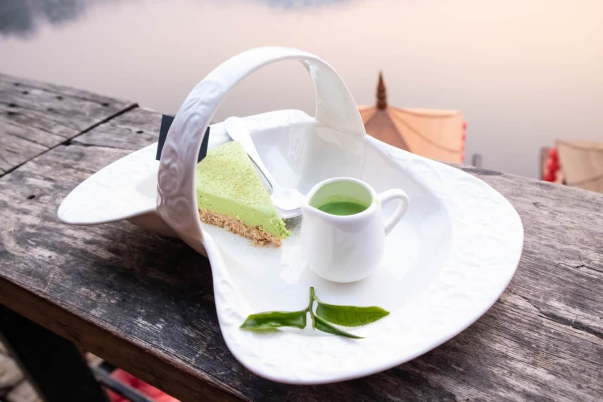 photo of match cake and matcha drink on a porcelain plate